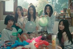 the girls are posing with balloons in front of them