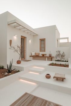 an outdoor living area with white walls and plants