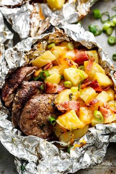 some food that is sitting in foil on top of a table with peas and pineapples