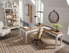 a living room filled with furniture and a clock on the wall next to a window