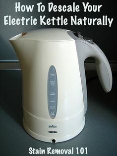 a white electric kettle sitting on top of a counter next to a black and gray wall