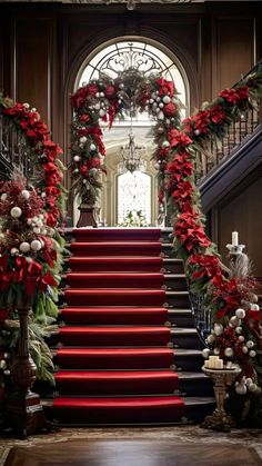 red carpeted stairs decorated with garland and poinsettis