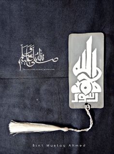 a tasseled bookmark with an arabic calligraphy on the front and back