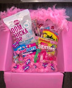 a pink box filled with candy and candies