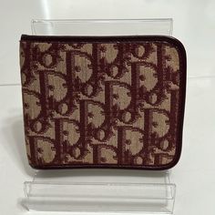 Authentic Dior Wallet. Can Be Unisex! Maroon Leather And Ran Canvas. Very Good Preloved Condition. Interior Soft Leather With Card Slot, Snap Coin Pouch And Bill Slot. Inner Snap Is Snappy With Some Coin Reside. Some Light Scratching And Indention From Snap Inside. No Tears Or Rips. Outer Canvas Has Some Slight Overall Discoloring But No Individual Stains. Bending Of Leather At Folds With Slight Cracks On Inside, But No Wear Of Leather Or Exposed Piping. No Wear On Corners. Overall Very Good Con Designer Tan Wallets For Travel, Designer Tan Wallet, Designer Compact Travel Wallet, Compact Designer Travel Wallet, Christian Dior Men, Bifold Wallet Men, Dior Men, Men Dior, Maroon Leather