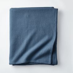 a blue towel folded on top of a white surface