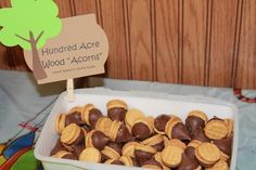 there is a container full of almonds on the table with a sign that says hundred acne wood - acoms