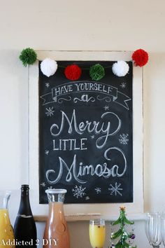 a chalkboard sign that says have yourself a merry little minnesota with pom - poms