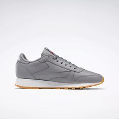 This Classic Leather sneaker is the cornerstone of our Classics collection. We revived and refreshed the time-honored monochromatic finish. Its solid construction and cushion make this men's shoe a triple threat of fashion function and feel. Gray Slip-resistant Running Shoes For Streetwear, Gray Slip-resistant Sneakers For Streetwear, Clown Shoes, White Reebok, Reebok Classic Leather, Functional Fashion, Men's Shoe, Triple Threat, Reebok Classic