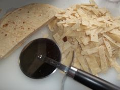 some tortilla chips and a spoon on a table