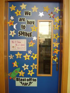 a door decorated with stars and the words we are here to shine