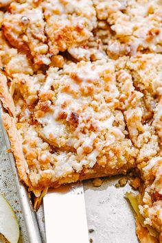 a close up of a pie on a pan with a knife