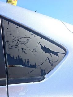 a car with an alien scene painted on it's side window