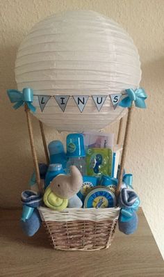 a basket filled with baby items sitting on top of a wooden table next to a wall