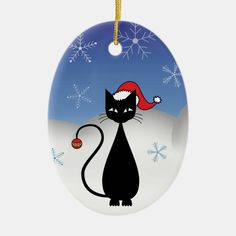 a ceramic ornament with a black cat wearing a santa hat