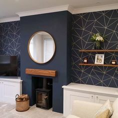 a living room with blue walls, white furniture and a large mirror on the wall