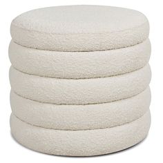 a stack of white round pillows on top of each other