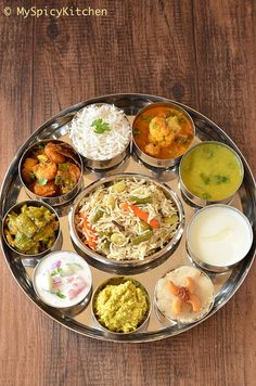 a metal plate filled with different types of food