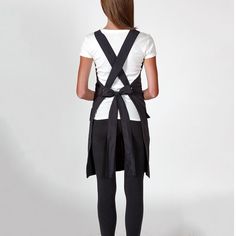 the back view of a woman wearing black suspenders