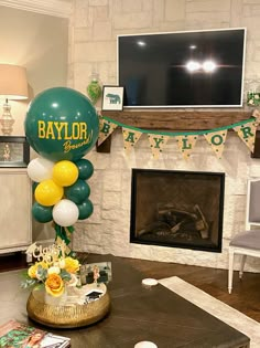 a living room filled with furniture and balloons in front of a tv mounted on the wall