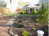 a garden with stone steps leading up to a house