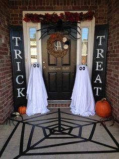 two halloween decorations on the front door of a house