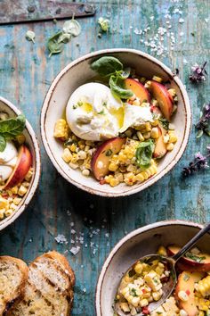 three bowls filled with corn and peaches next to slices of bread on a table