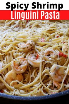 a pan filled with pasta and shrimp on top of a wooden table next to the words spicy shrimp linguini pasta