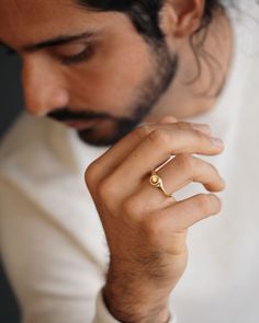 A round button of gold, gently pressed atop a noble signet ring. With refined proportions and a simplified silhouette, the Button Ring is a modern signifier of strength, integrity, and wholeness. Ideal as a wedding band, a milestone ring, or for everyday wear. For a larger version of this ring, see the Button Ring Grand or view the entire Button Collection. Materials and Dimensions Cast in solid 18K yellow gold~8mm button diameterHand stamped on the interior with our George Rings™ crown Luxury Jewelry Brands, Mens Gold Jewelry, Round Button, Button Ring, Mens Gold, Signet Ring, Custom Engraving, Jewelry Branding, Luxury Jewelry