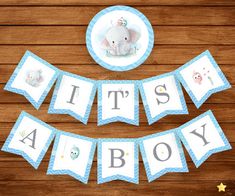 it's a boy banner with an elephant and other baby items on the table