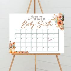 an easel with a baby's birth calendar on it and the words guess the arrival date of baby smith