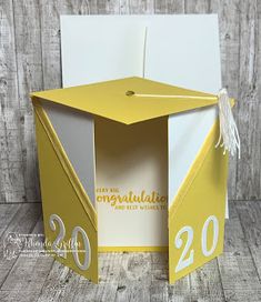 an open yellow and white box with the number twenty on it's side, in front of a wooden background