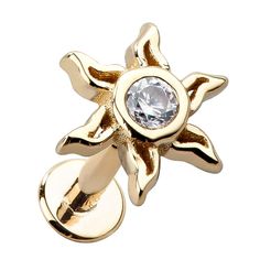 a close up of a gold ring with a diamond in the center and an open flower design