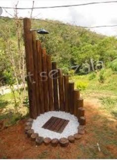 an outdoor fire pit made out of wood and stone in the shape of a circle