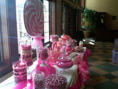 a table topped with lots of candy and lollipops on top of it