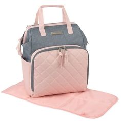 a pink and grey diaper bag sitting on top of a mat