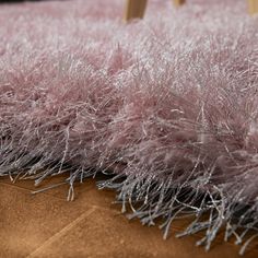 an area rug that has been covered with pink fur