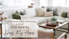 a living room filled with lots of furniture and pillows on top of a wooden table