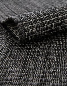 a close up view of a black and grey textured fabric