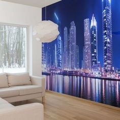 a living room filled with furniture next to a large city skyline wallpapered in blue and white