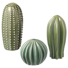 two green vases sitting next to each other on a white background, one is shaped like a cactus