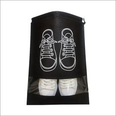 two tennis shoes in a black bag with white laces on the bottom and inside