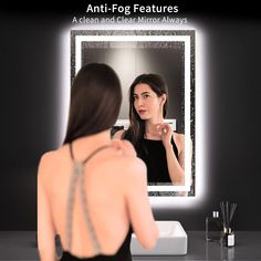 a woman is looking at herself in the mirror