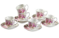 a set of six coffee cups and saucers with pink flowers on the rims