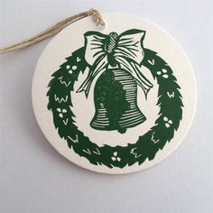 a green and white ornament with a bow on it