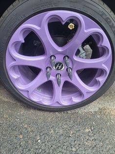 a purple car wheel with hearts on it