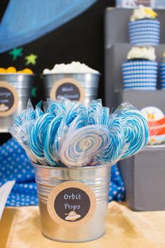 some lollipops are in a bucket on a table