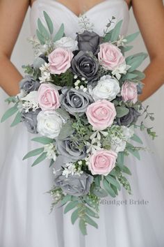 a bridal holding a bouquet of flowers and greenery