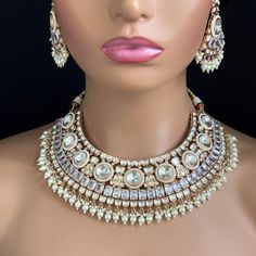 Adorn yourself with timeless elegance with our Bridal White Fine Kundan Gold Plated Necklace Set. Perfect for Indian and Pakistani weddings, this exquisite bridal jewelry features intricate gold-plated designs and sparkling kundan stones. Experience the allure of tradition and make your special day unforgettable. Gold-plated foiled Kundan necklace set. Regular Size And Adjustable Ships from California, USA Delivery in 2-5 business days in the USA. Color, shades, and texture displayed may slightly vary from the actual product due to digital image limitations. We request you consider these minor variations. Please expect the possibility of some slight imperfections when buying handmade jewelry. Please let me know if you have any questions. Arrives in a gift box. Thank you so much for visitin Traditional White Kundan Necklace For Marriage, White Kundan Necklace With Intricate Design For Marriage, White Kundan Necklaces For Marriage, Bollywood Kundan Necklace For Marriage With Intricate Design, Bollywood Kundan Necklace With Cutdana For Marriage, White Bridal Necklace With Meenakari For Marriage, Kundan Bridal Necklace For Diwali Marriage, Festive Kundan Cutdana Necklace For Marriage, Silver Kundan Necklace For Marriage Festivals