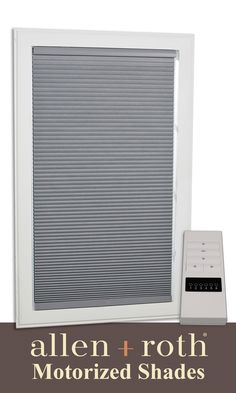 a white window with the words allen - roth motorized shades on it and an alarm clock